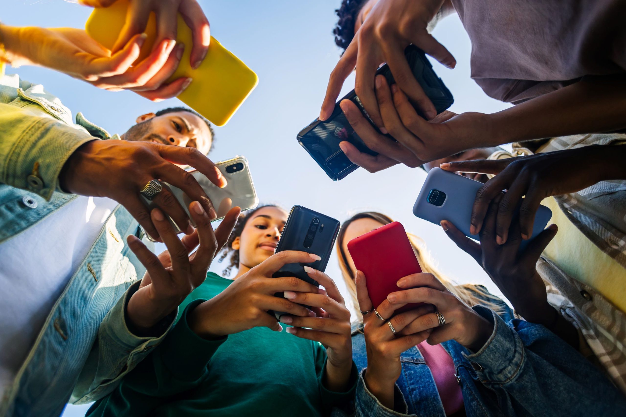 envato.com by xapdemolle young-group-of-people-using-mobile-phone-device